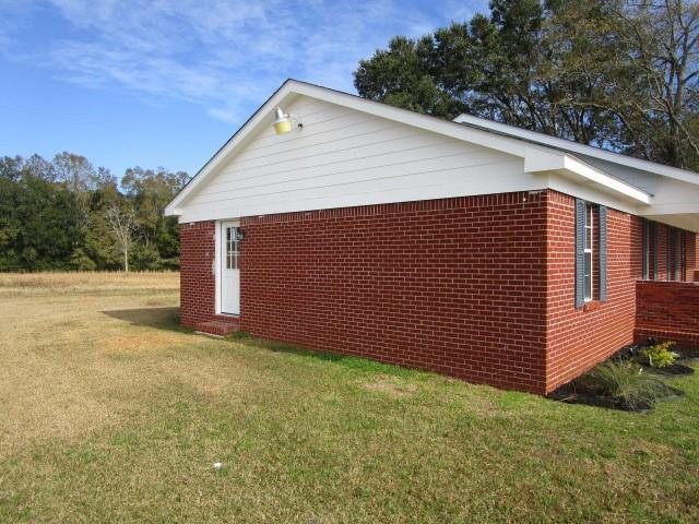 view of side of home featuring a lawn