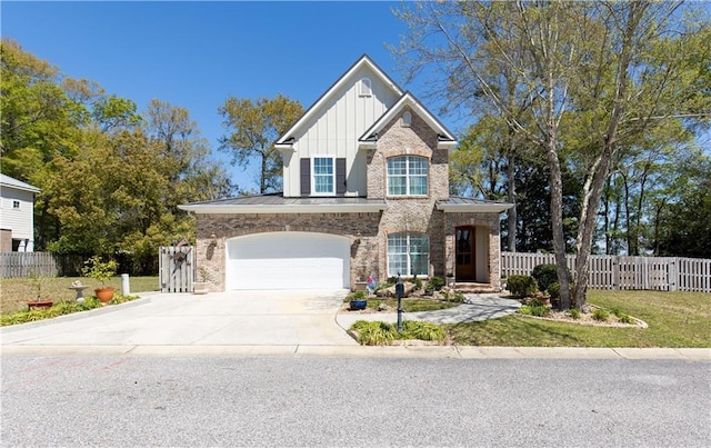 view of front of property with driveway, a front yard, an attached garage, fence, and board and batten siding