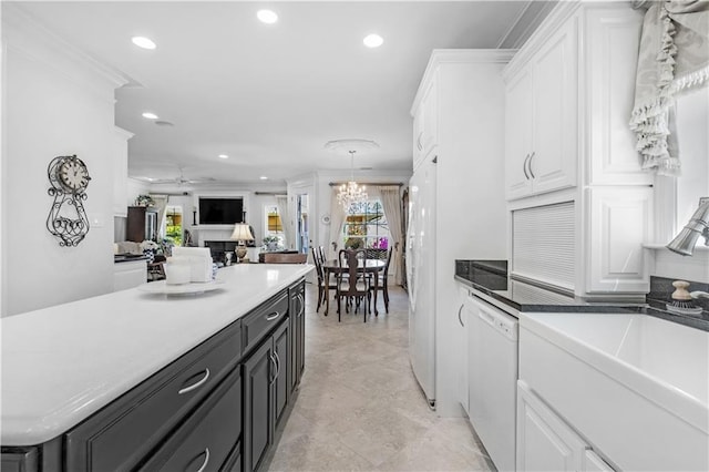 kitchen featuring white cabinets, crown molding, recessed lighting, a sink, and white dishwasher