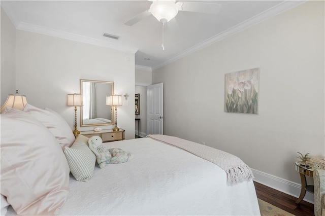 bedroom featuring visible vents, crown molding, baseboards, ceiling fan, and wood finished floors