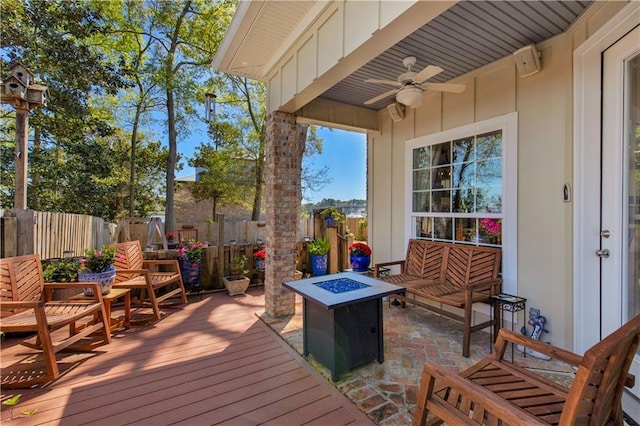 deck featuring a fire pit, fence, and ceiling fan