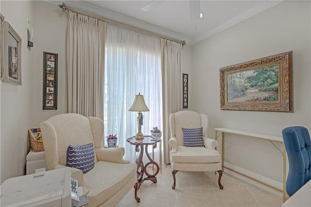 living area featuring baseboards, a ceiling fan, tile patterned floors, and crown molding