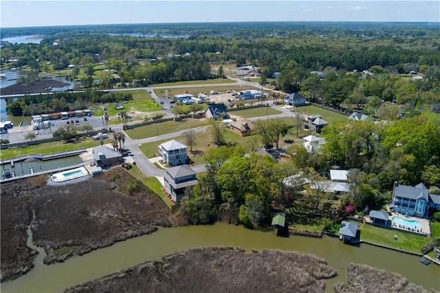 bird's eye view with a water view and a forest view