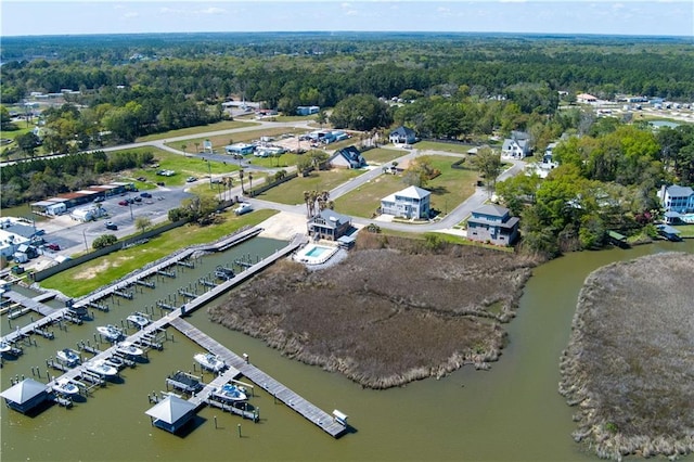 birds eye view of property featuring a water view and a view of trees