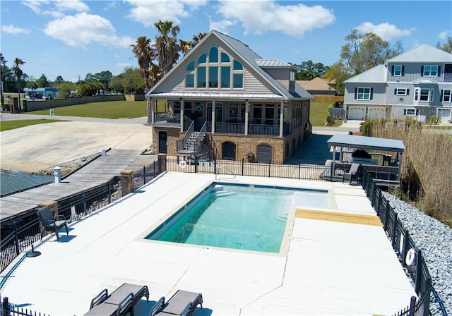 community pool featuring a patio, fence, and stairway