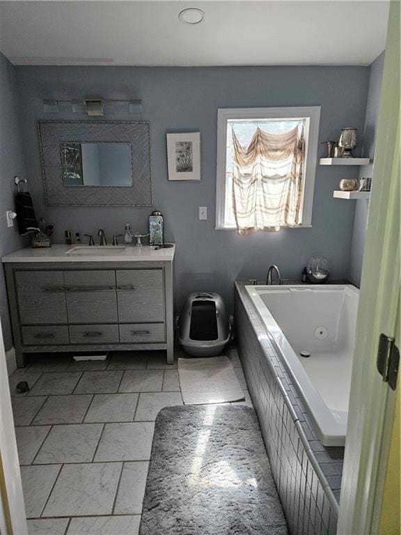 bathroom featuring a whirlpool tub and vanity