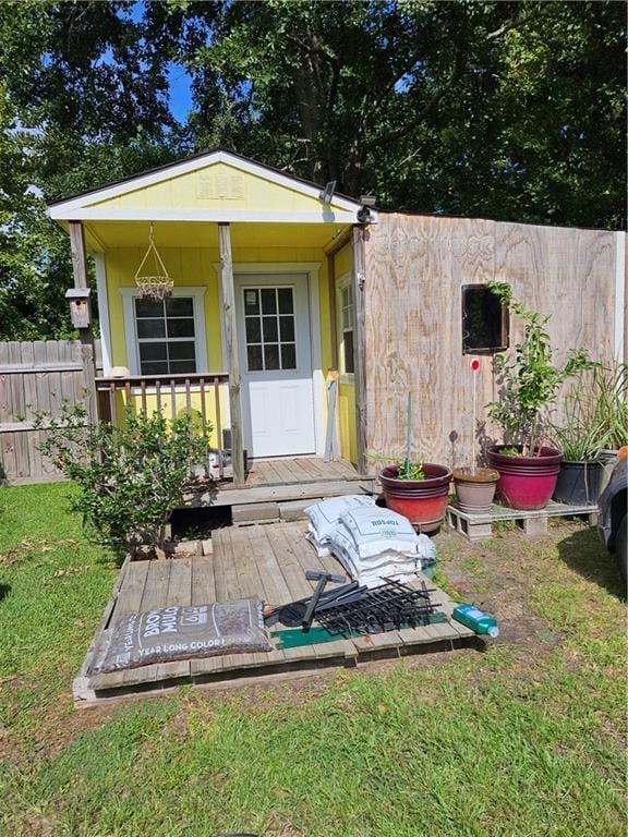 exterior space featuring an outdoor structure and fence