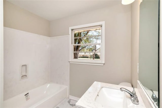 full bathroom with vanity and baseboards