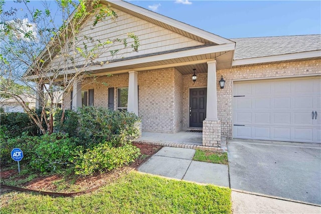 view of front of property featuring a garage and a porch