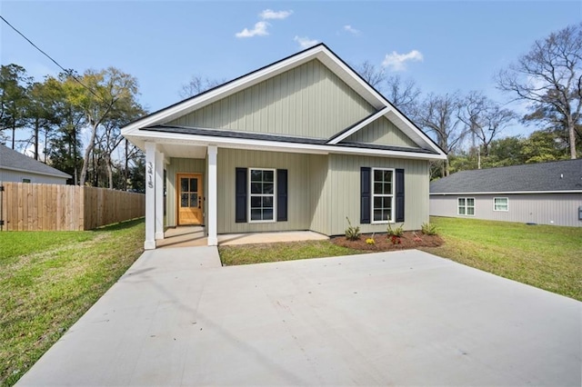 view of front of property featuring a porch, a front yard, and fence