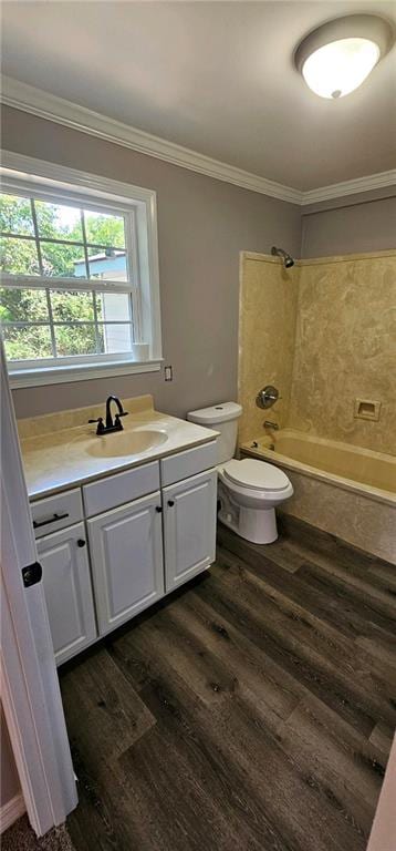 full bathroom featuring wood-type flooring, vanity, ornamental molding, bathtub / shower combination, and toilet