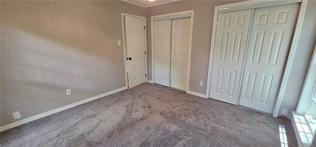 unfurnished bedroom with ornamental molding and carpet