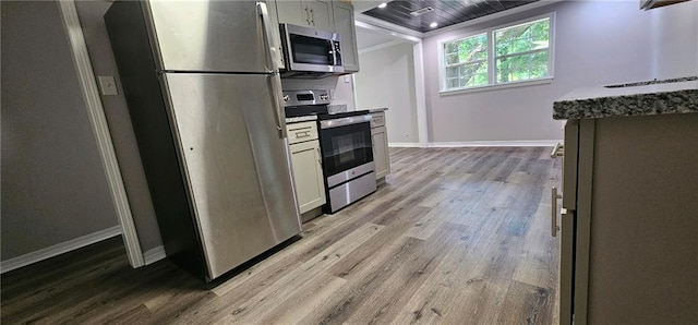 kitchen featuring light hardwood / wood-style floors, crown molding, white cabinetry, and stainless steel appliances