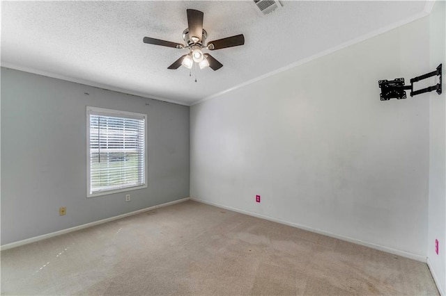 carpeted empty room featuring a textured ceiling, a ceiling fan, visible vents, baseboards, and ornamental molding