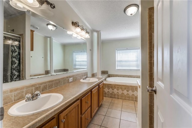 full bath featuring tasteful backsplash, a textured ceiling, a sink, and tile patterned floors