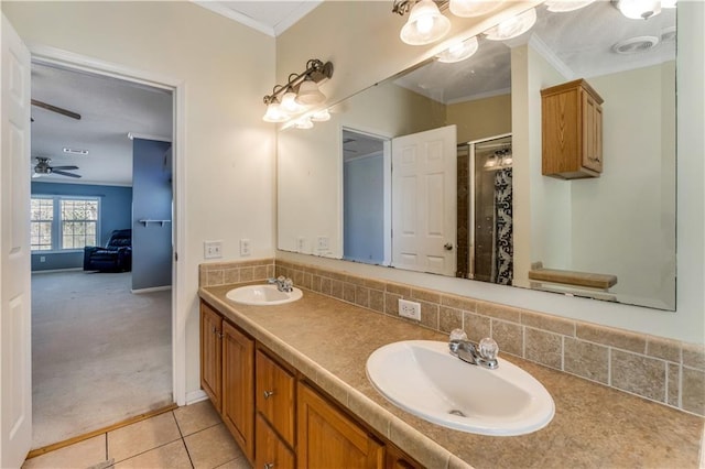 full bathroom featuring crown molding, a sink, backsplash, and double vanity