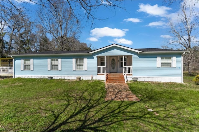 manufactured / mobile home featuring a porch and a front lawn