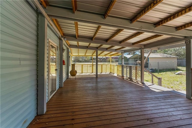 wooden deck featuring a yard and fence