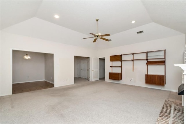 unfurnished living room featuring ceiling fan, lofted ceiling, carpet flooring, and a raised ceiling