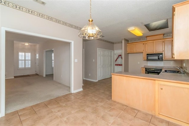 kitchen featuring light brown cabinetry, sink, hanging light fixtures, kitchen peninsula, and stove