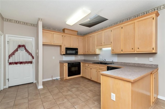 kitchen featuring sink, light tile patterned flooring, black appliances, and light brown cabinets