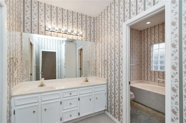 bathroom with vanity, tile patterned floors, a bathing tub, and toilet