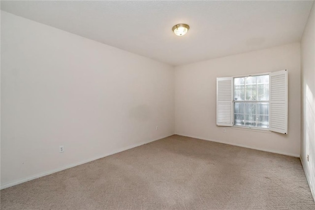 unfurnished room with light colored carpet