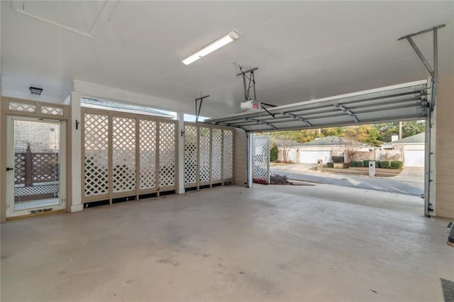 garage with a garage door opener and basketball hoop