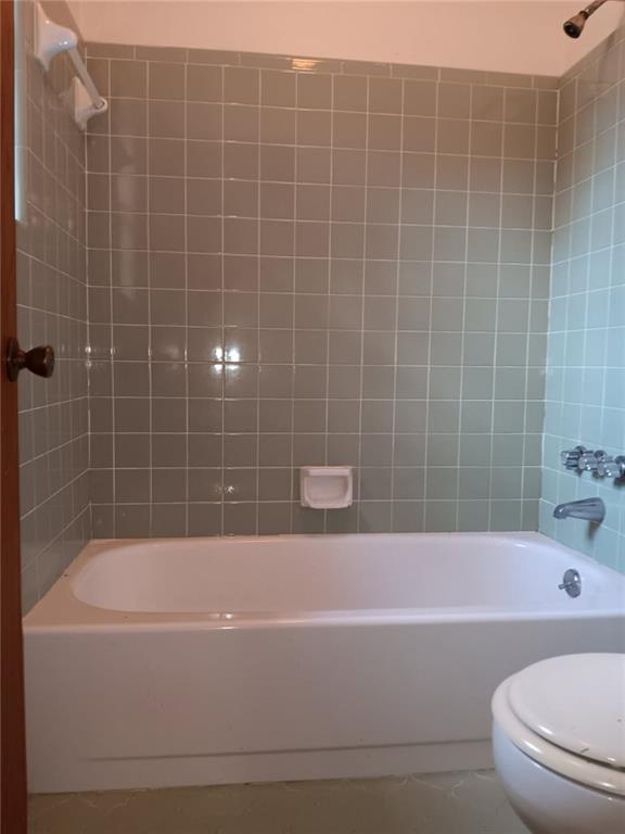 609 Gehrig Ave, Prichard, AL 36610 - full bathroom with tile patterned flooring and  shower combination