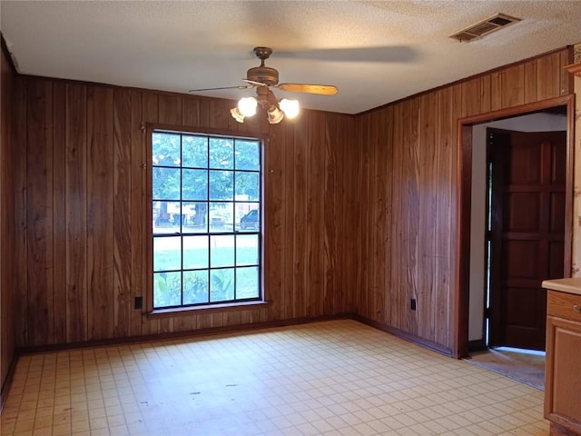 609 Gehrig Ave, Prichard, AL 36610 - unfurnished room featuring a ceiling fan, wooden walls, and light floors