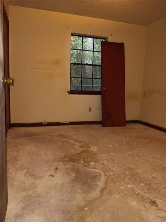 609 Gehrig Ave, Prichard, AL 36610 - empty room featuring unfinished concrete flooring and baseboards