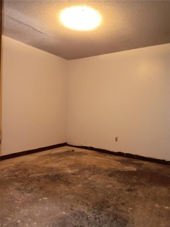 609 Gehrig Ave, Prichard, AL 36610 - empty room with a textured ceiling and unfinished concrete flooring