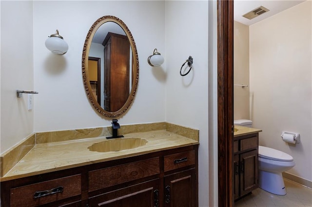 bathroom with tile patterned floors, vanity, and toilet