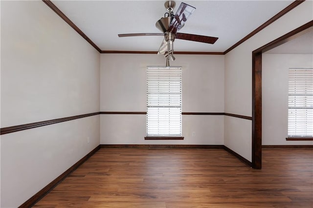 empty room featuring ceiling fan, plenty of natural light, dark hardwood / wood-style flooring, and crown molding