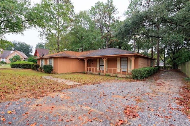 single story home with a porch