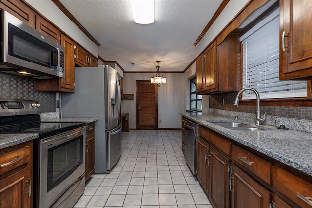 kitchen featuring backsplash, hanging light fixtures, sink, and stainless steel appliances