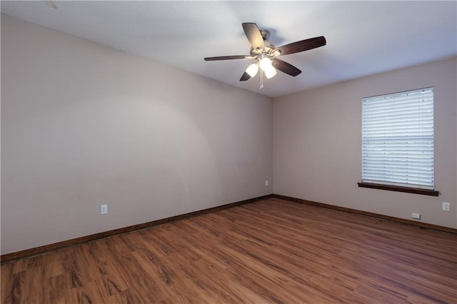 spare room with ceiling fan and dark hardwood / wood-style floors