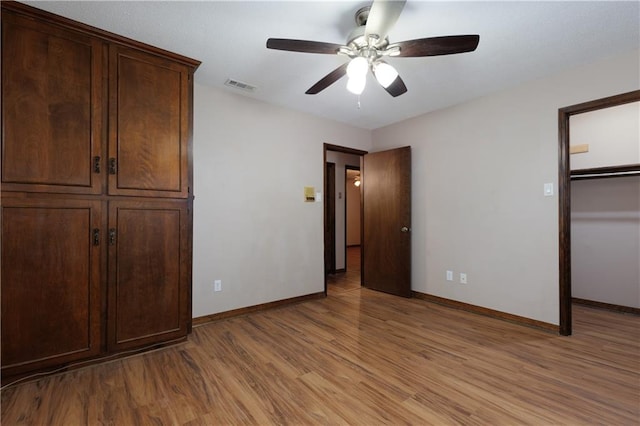 unfurnished bedroom with ceiling fan and light hardwood / wood-style flooring