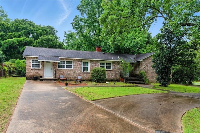 409 Byron Ave E, Mobile, AL 36609 - ranch-style house with driveway, brick siding, a front yard, and a chimney