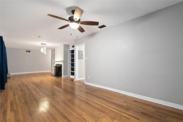 409 Byron Ave E, Mobile, AL 36609 - unfurnished living room featuring a ceiling fan, a fireplace with flush hearth, and wood finished floors