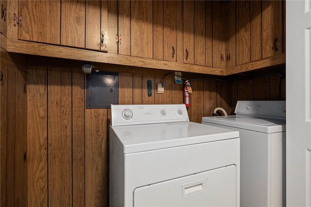 409 Byron Ave E, Mobile, AL 36609 - washroom featuring cabinet space, washer and clothes dryer, and wood walls