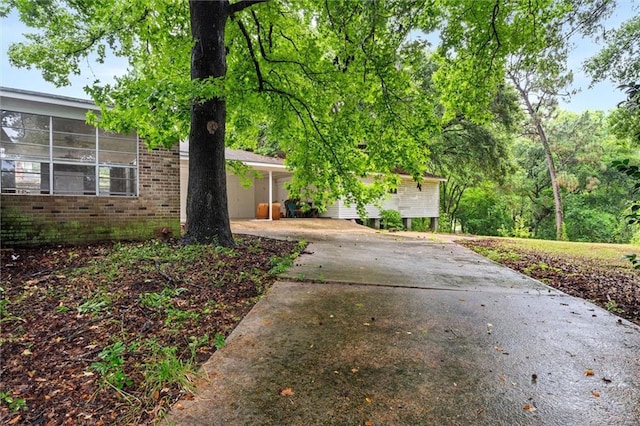 409 Byron Ave E, Mobile, AL 36609 - view of front of property with driveway, brick siding, and an attached carport