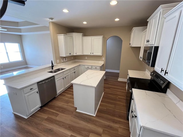 kitchen featuring a kitchen island, dark wood-type flooring, sink, stainless steel appliances, and white cabinetry