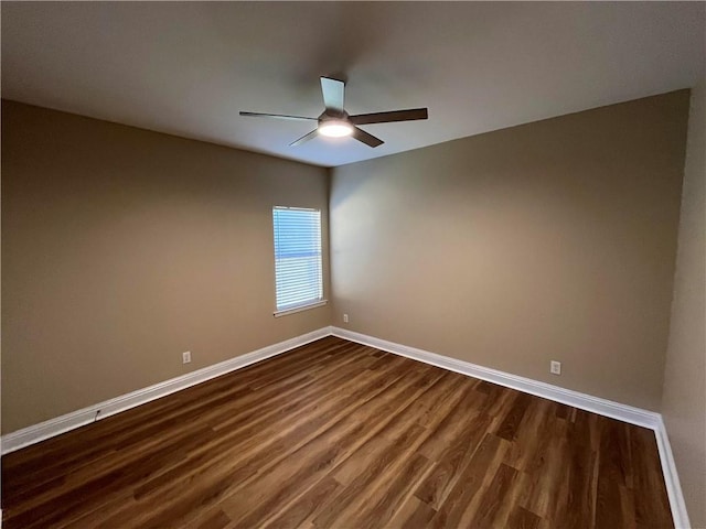 empty room with ceiling fan and dark wood-type flooring