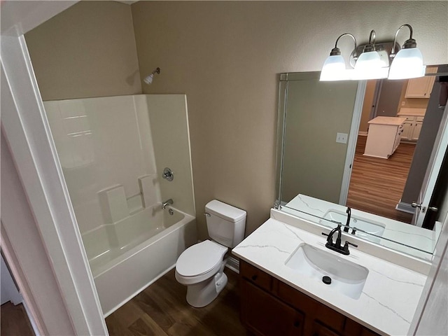 full bathroom with bathing tub / shower combination, hardwood / wood-style flooring, vanity, and toilet