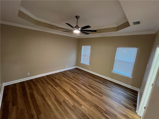 spare room featuring ornamental molding, a tray ceiling, hardwood / wood-style flooring, and ceiling fan