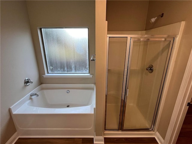 bathroom featuring separate shower and tub