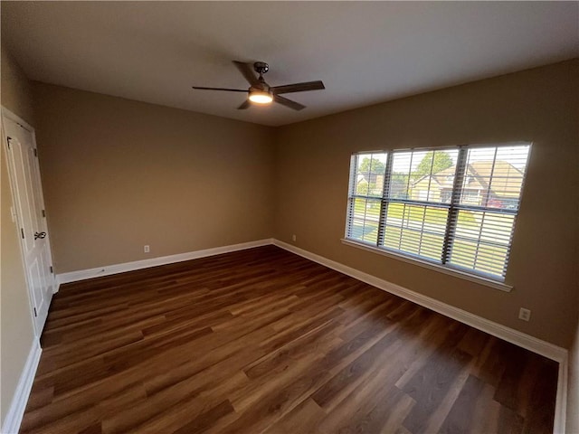 unfurnished room with dark hardwood / wood-style floors and ceiling fan