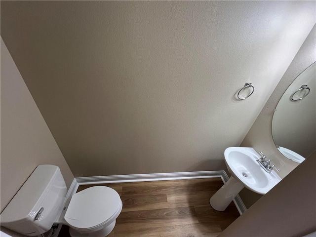 bathroom with wood-type flooring and toilet