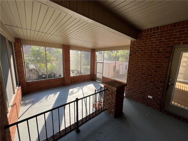 unfurnished sunroom featuring wood ceiling